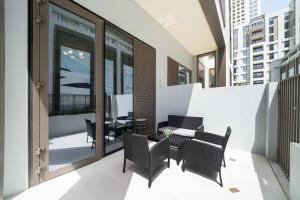 a balcony with chairs and a table on a building at Brand New 1BDR In Summer At Creek Beach in Dubai