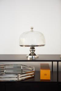 a silver lamp on a black table with a box at The Townhouse in Udine