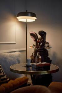 a table in a living room with a lamp at The Townhouse in Udine