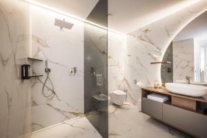 a bathroom with a sink and a shower at Timeless Dolomites Apartments in Dobbiaco