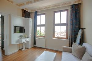 a living room with a couch and a tv at IQ Hotel Galatasaray in Istanbul