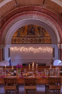 a dining room with a long table and a fireplace at Mountain Church in Capel-Curig