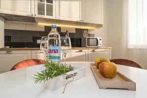 a bottle of water on a table in a kitchen at Studio apartments Marcel in Split