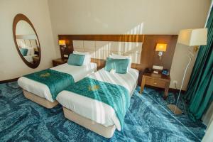 Postel nebo postele na pokoji v ubytování JRW Welmond Hotel