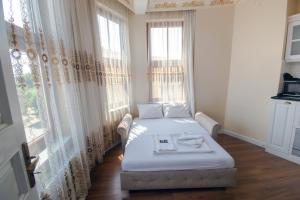 a bedroom with a bed and a large window at IQ Hotel Galatasaray in Istanbul