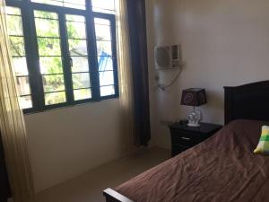 a bedroom with a bed and a window at Casa Erlinda, modern newly built house 3BR for 8! in Tigaon