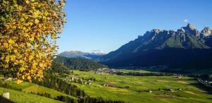 a view of a valley with mountains in the background at Timeless Dolomites Apartments in Dobbiaco