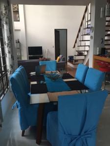 a living room with a table and blue chairs at Casa Erlinda, modern newly built house 3BR for 8! in Tigaon
