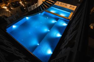 an overhead view of a swimming pool at night at Guulab Haveli in Jaisalmer