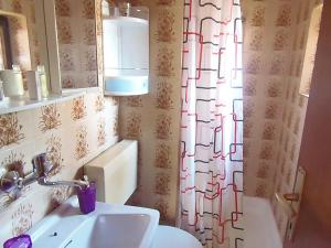 a bathroom with a sink and a shower curtain at Sunflower Apartment in Opatija +11 photos