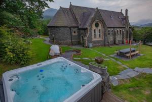 a large hot tub in front of a church at Mountain Church in Capel-Curig