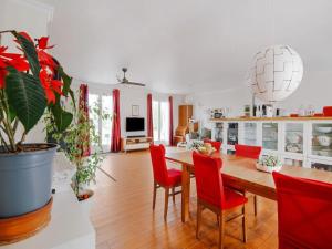 a kitchen and dining room with a table and red chairs at 5 bedroom-5 bathroom Gîte with free wifi and parking chez Mostarlić B&B in Bouconville