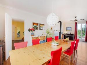 a dining room with a wooden table and red chairs at 5 bedroom-5 bathroom Gîte with free wifi and parking chez Mostarlić B&B in Bouconville