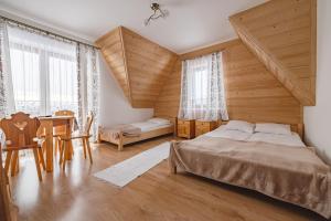 a bedroom with a bed and a table and chairs at U Marii & Mariana in Leśnica