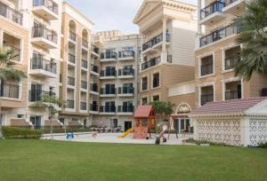 a playground in front of a large apartment building at Modern Studio In Resortz Residence - Arjan in Dubai
