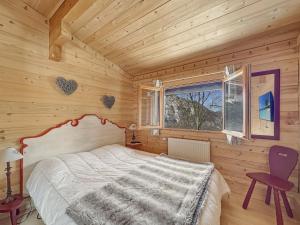 a bedroom with a bed in a wooden room at CH201 Chalet 6 Pers in Les Carroz d'Araches