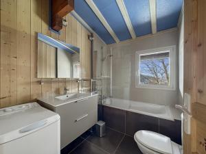 a bathroom with a toilet and a sink and a tub at CH201 Chalet 6 Pers in Les Carroz d'Araches