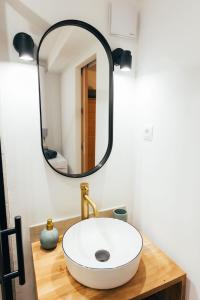 a bathroom with a white sink and a mirror at Studio cozy centre avec Parking in Grasse
