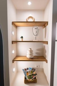 a room with wooden shelves and a basket at Studio cozy centre avec Parking in Grasse