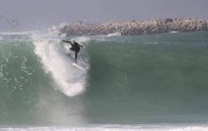 a man riding a wave on a surfboard in the ocean at MEHDIA PLAYA in Kenitra