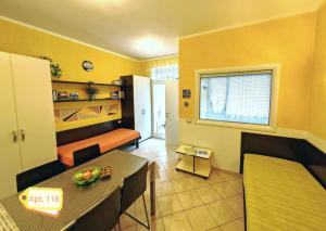 a living room with a table and a dining room at Garda Apartments in Euroresidence in Garda
