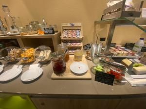 a kitchen counter with food on a table at Hotel sleep&stay - Self Check-in in Eglisau
