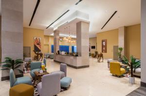 a lobby with a waiting area and a horse in the middle at HDB Financial District in Riyadh
