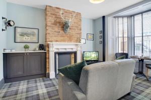 a living room with a couch and a fireplace at Urban Elegance - Luxe 1-Bed Haven in Hartlepool in Hartlepool