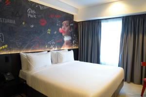 a hotel room with a bed and a painting on the wall at SO City Hotel Adults Only in St. Julianʼs