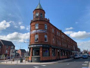 a brick building with a clock tower on top of it at The Donard Hotel in Newcastle