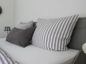 a bed with three pillows on top of it at Cathedral day "Hygge" in Kronsgaard