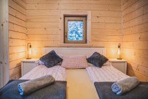a bedroom with two beds in a log cabin at Domek u Cianka w Kościelisku in Kościelisko