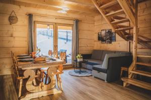 a living room with a couch and a table in a cabin at Domek u Cianka w Kościelisku in Kościelisko