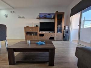 a living room with a coffee table and a tv at MALVASIA 5 in Famara