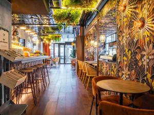 a restaurant with tables and chairs and a bar at ibis Paris Place d’Italie 13ème in Paris