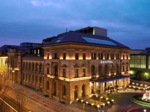 a large brick building with lights on it at Sofitel Munich Bayerpost in Munich