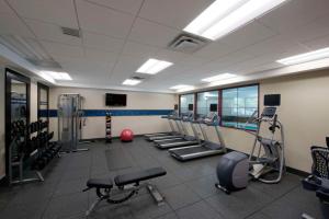 a gym with a row of treadmills and machines at Hampton Inn & Suites Lake Placid in Lake Placid