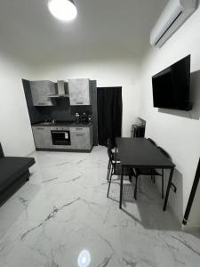 B&B Puma official في نابولي: غرفة معيشة مع طاولة ومطبخ