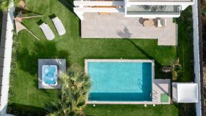 an overhead view of a pool in a yard with palm trees at Martinis Villas in Kremasti