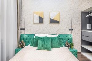 a bedroom with a green bed with a green headboard at Extreme Central - Luxy Stay in Budapest