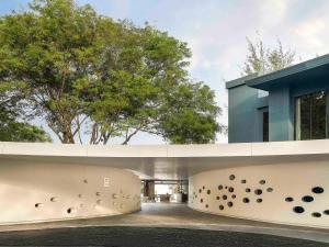 a building with a wall with holes in it at Mercure Rayong Lomtalay Villas & Resort in Mae Pim