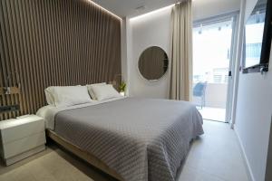 a bedroom with a bed and a large window at XeVa Studio in Mastichari