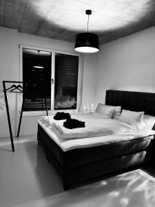 a black and white bedroom with a large bed at Design Flat Hidden Pearl Davos in Davos