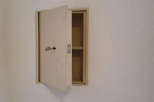 a white door with a mirror on a wall at Laurin Apartment L62 in Dresden