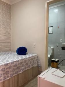 a room with a bed and a bathroom with a toilet at Pousada A Casa Portuguesa in Cabo de Santo Agostinho