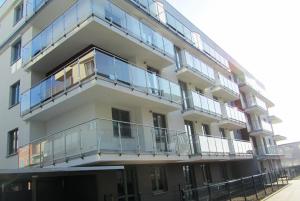 an apartment building with balconies on the side of it at Apartament Scandynawski in Kołobrzeg