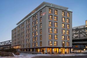 a large building with many windows in a city at Vienna House Easy by Wyndham Berlin Potsdamer Platz in Berlin