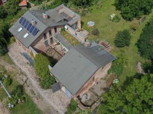 an aerial view of a large house with a roof at Große Wohnung in alter Brennerei in Krebsow