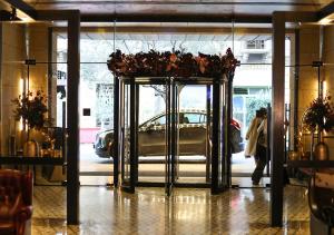 a revolving door with a car parked in a building at Saifi Suites in Beirut