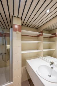 a bathroom with a sink and a shower at Vayamundo Oostende - Apartments in Ostend
